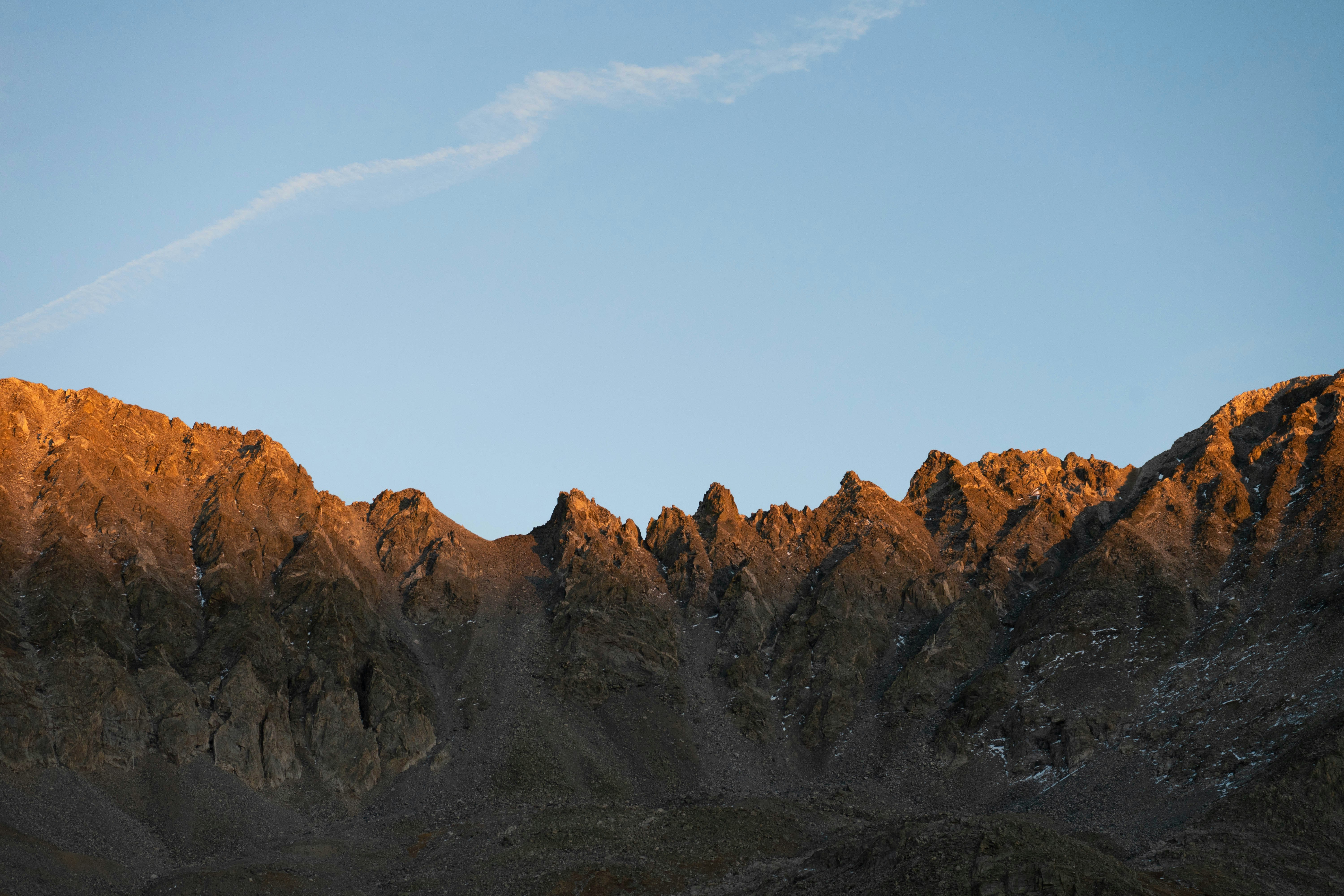 brown rocky mountain under blue sky during daytime